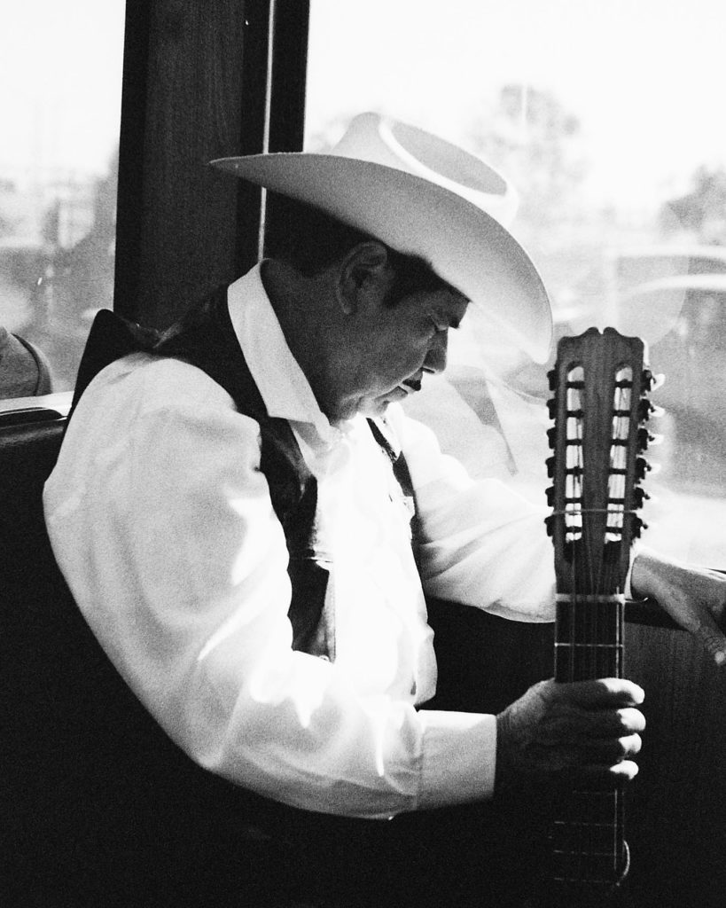 Image of man with hat and guitar