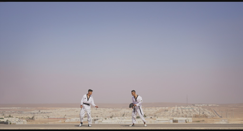 Two athletes sparring in desert landscape - We Dare to Dream film still